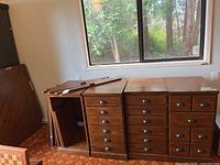 Three pedestal cabinets positioned under window