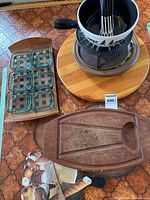 Group shot showing lazy Susan, fondue set, condiment tray, carving board and printed board