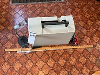 Sewing machine inside hard case with magnifiers and tools visible