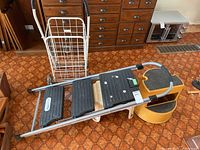 All four items together: Cosco ladder, grocery cart, yellow kick stool, white stool