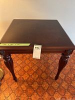 Full view of dark wood side table showing top and legs