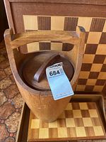 Teak ice bucket in front of chess board