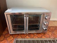 Front view showing double doors, handles, interior rack