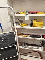 Ladder and shelves of assorted tools