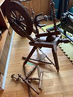 Overall spinning wheel showing detached legs and flyer