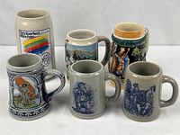 Group shot of all six ceramic beer steins showing size and variety