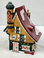 Front view of porcelain building showing façade, tower and signage