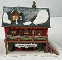 Front view of porcelain Santa’s Woodworks building