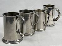 All four pewter mugs lined up
