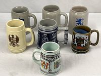 Group of seven German beer steins and mugs