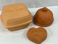 All three terracotta pieces: square Oven Brique baker, round onion/garlic baker, heart casserole