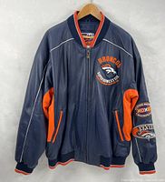 Front view of navy and orange Denver Broncos Super Bowl XXXIII leather jacket on hanger