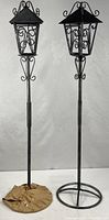 Full view of both metal lanterns on stands