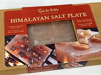 Front of sealed Sur La Table Himalayan Salt Plate box showing product through window