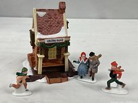 Front view of building with three skater figurines