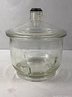 Full view of glass desiccator jar with lid