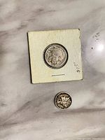 Coin in cardboard flip (obverse) and loose Mercury dime (reverse)