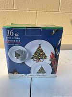Front of box showing 16-piece fine china Christmas tree dinner set