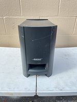 Front view of Bose PS2-1 subwoofer showing Bose logo and front port