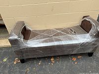 Full loveseat wrapped in stretch film