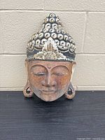 Front view of carved Buddha head shelf