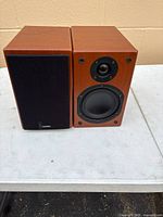 Pair of Denon SC-M37 speakers, one with grille on, one without