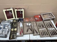 Overall view of boxed flatware and utensil sets on tables