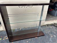 Full front view of bar display showing wood frame, glass shelves, stemware rack