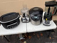 All four kitchen appliances displayed on table