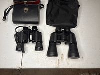 Two binoculars and two cases on table