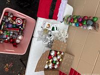 Top view of tote, Santa bag, ornaments in box and tube
