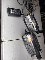 Pair of Sony Handycam camcorders with cables and AC adapter on table