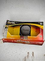 Front of open Master Lock Magnum box showing disc padlock in center