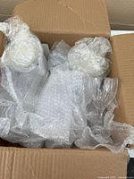 Cardboard box with multiple bubble-wrapped crystal flutes