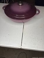 Side view of purple enameled Dutch oven with lid