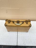 closed suitcase viewed from top, showing handle and hardware