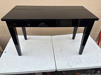 Bench closed, showing glossy black finish and overall form