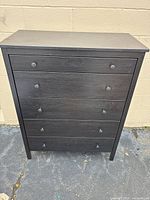 Front view of tall narrow 4-drawer chest showing drawers, pulls and overall condition