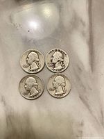 Obverse of four Washington quarters showing dates 1941, 1943, 1943, 1949