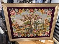 Full view of framed tapestry showing entire scene and frame