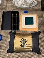 Lot overview showing pillow, chopstick set, stacked plates