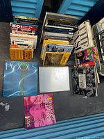 Overview of stacked books, coffee table books, some vinyls