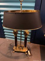 Front view of bouillotte lamp showing shade, columns, base, cord