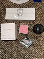 Four candles: Diptyque box, Stuart Weitzman box, aqua glass jar, black jar