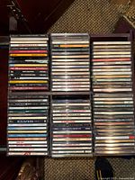 Drawer containing four vertical stacks of approximately 85 CD jewel cases