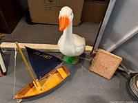 Group view of goose figure, sailboat model, and tapestry journal