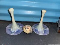 Front view of two candlesticks and penguin figurine