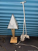 Triangular glass table lamp and white Streamline floor lamp side by side