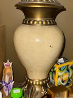 Close-up of lamp body showing ceramic finish and bronze-tone base