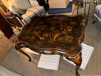 Full view of tea table showing scalloped shape and cabriole legs